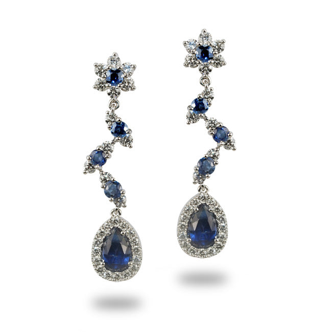 White gold rosette earrings with diamonds and sapphires.