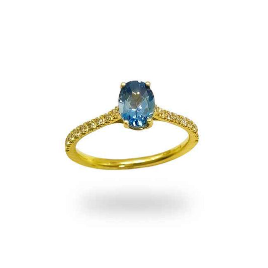 Anillo en oro amarillo con diamantes talla brillante y topacio azul